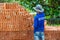 Construction worker picks up terra cotta bricks from the stacks