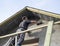 Construction worker plastering the facade of the house