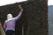 Construction worker - plastering and smoothing concrete wall with cement by a steel trowel - spatula aligns.