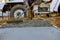 Construction worker pour cement for sidewalk in concrete works with mixer truck with wheelbarrow