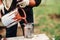 construction worker pouring liquid paint intro spray gun