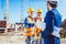 Construction worker in protective uniform shaking hands with businessman