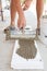 Construction worker puts a gypsum on styrofoam with spatula.