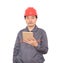 Construction worker with red hard hat holding ipad in hand standing in front of white background