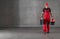 Construction Worker in Red Uniform Walking with Toolboxes in His Hands