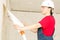 Construction worker removing wallpaper