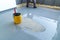 Construction worker renovates balcony floor and spreads watertight resin and glue before chipping and sealing