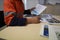 Construction worker setting on a chair holding a pen signing of site safety induction rule and regulation