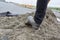 Construction worker shovels fresh cement for house construction