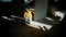 Construction worker sits near the wall and open toolbox at construction site. Shadows from man