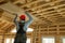 Construction worker thermally insulating eco wooden frame house