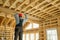 Construction worker thermally insulating eco wooden frame house