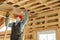 Construction worker thermally insulating eco wooden frame house