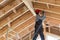 Construction worker thermally insulating eco wooden frame house