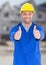 Construction Worker with thumbs up in front of construction site