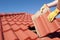 Construction worker tile roofing repair house