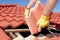 Construction worker tile roofing repairs