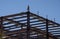 A construction worker on the the top of an iron beam framing of a commercial building under construction