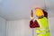 Construction worker used electric drill installation ceiling