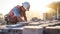 construction worker using cement blocks for building a house at construction site