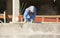 Construction Worker Using Cement Sander