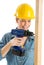 Construction Worker Using Cordless Drill On Wooden Plank