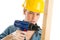 Construction Worker Using Cordless Drill On Wooden Plank