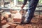 Construction worker using an grinder for cutting and sawing construction bricks