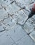 Construction worker using a handheld demolition hammer and wall breaker to chip away and remove old floor tiles during renovation