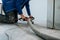 Construction worker using machine polishing surface floor smoothing and finishing hardener or epoxy concrete in the factory