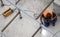 Construction worker welding a metal profile square structure, outdoors