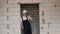 Construction worker in a white hard hat stands in the doorway of a new apartment