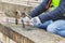 Construction worker working with hammer near concrete blocks