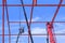 Construction workers with crane truck are installing slings wire ropes to secure metal roof structure of factory building