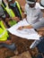 Construction workers discuss among themselves regarding technical issues at the construction site.