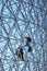 Construction workers doing maintenance job on the steel bars of the biosphere environment museum in Montreal, Quebec, Canada