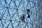 Construction workers doing maintenance job on the steel bars of the biosphere environment museum in Montreal, Quebec, Canada