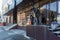 Construction workers drill a hole with a water hammer in the porcelain tile for fixing handrails on the porch for the store