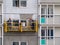 Construction workers installers high-rise workers industrial climbers, painters on the lift paint the facade of the building, comp