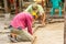 Construction workers are laying concrete pavement stone for footpath work at the construction site. Paving stone worker is putting