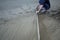 Construction workers leveling poured liquid concrete with trowels