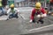 Construction workers leveling wet concrete has been poured.