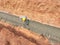 Construction workers are levelling a layer of lean concrete in the trenches at the construction site.