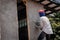 Construction workers plastering building wall using cement plaster