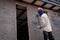 Construction workers plastering building wall using cement plaster