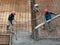 Construction workers pour wet concrete using a hose from the elephant crane or concrete pump crane at the construction site.