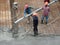 Construction workers pour wet concrete using a hose from the elephant crane or concrete pump crane at the construction site.