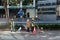 Construction workers repair pavement on a downtown street.