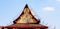 Construction workers repairing or fixing roof of ancient temple and clear blue sky background with copy space at Wat Phra Sri Ratt