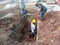 Construction workers repairing underground utility services pipe